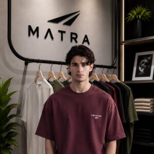 Model wearing the Matra maroon heavyweight drop shoulder tee with black trousers in the Matra store in Dhaka