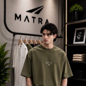 Model wearing the Matra olive heavyweight drop shoulder tee with black trousers in the Matra store in Dhaka